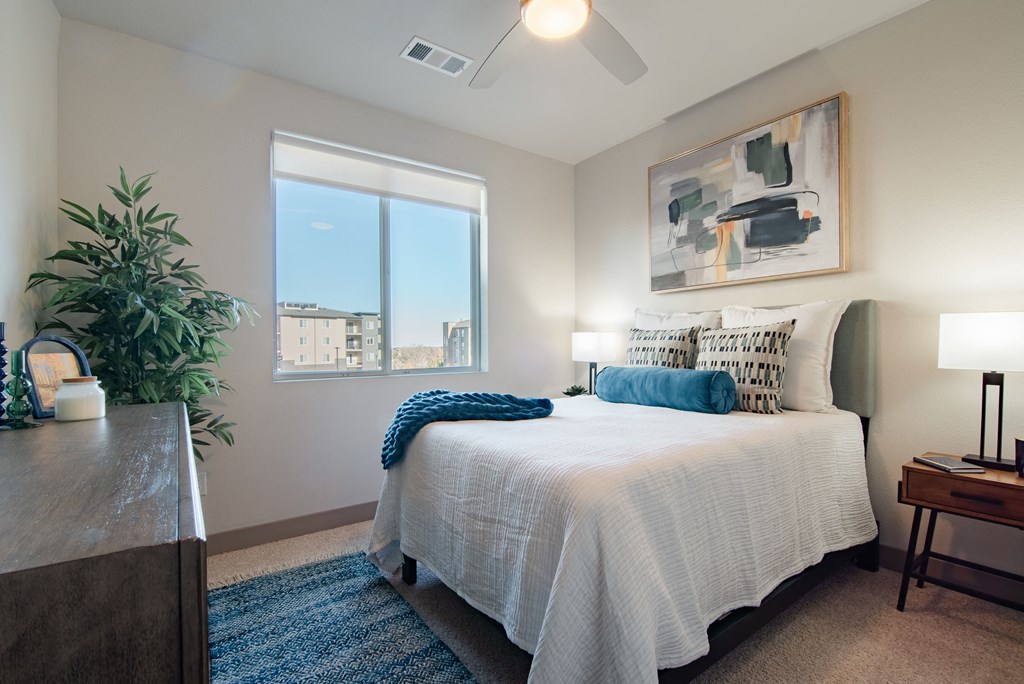 a bedroom with a large bed and a window at Parkside at Littleton Village, Littleton, CO