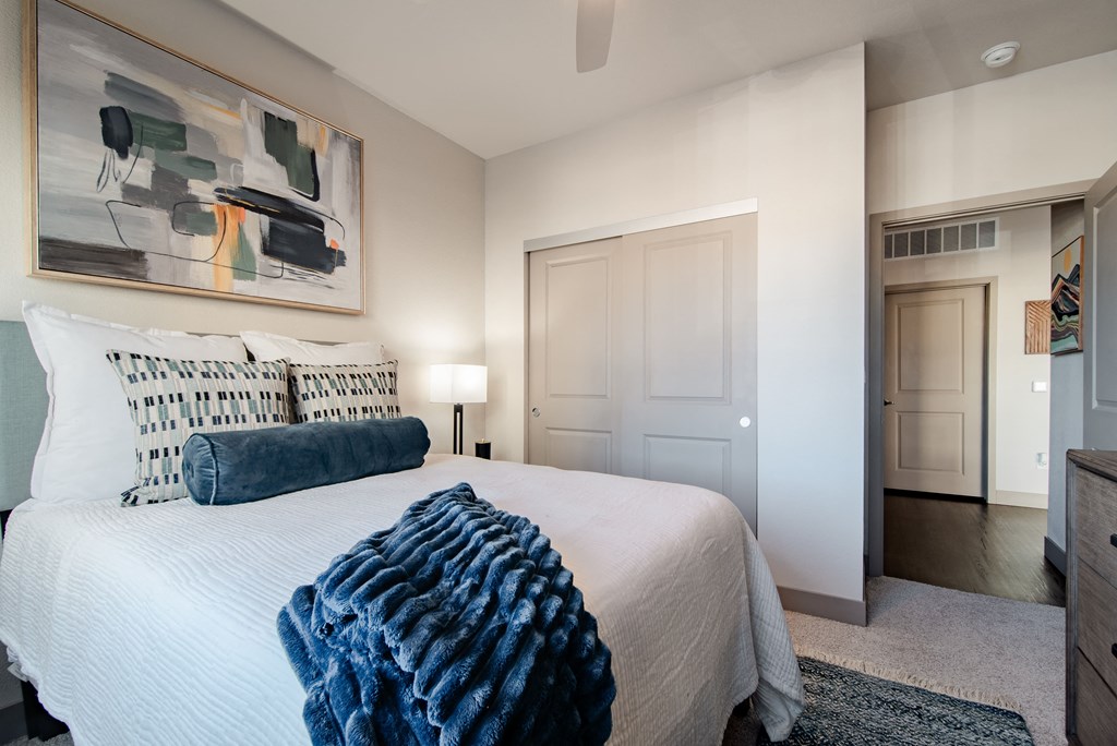 a bedroom with a large bed and a painting on the wall at Parkside at Littleton Village, Littleton, CO