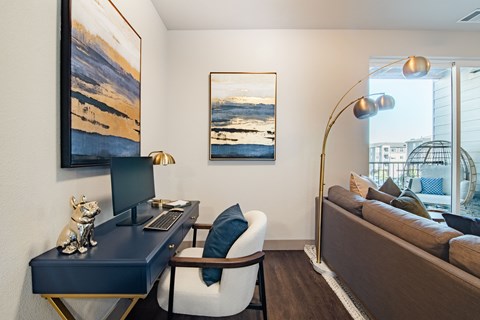 a living room with a desk with a computer and a couch at Parkside at Littleton Village, Littleton, CO