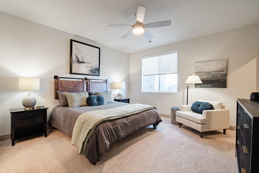 an empty bedroom with a bed and a ceiling fan at Parkside at Littleton Village, Littleton, Colorado