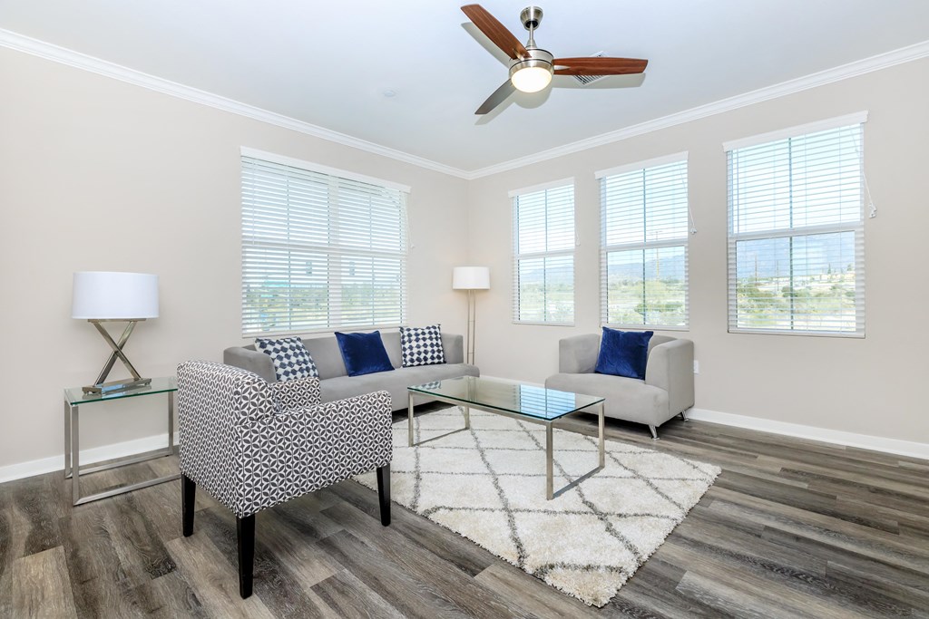 a living room with couches and a glass coffee table