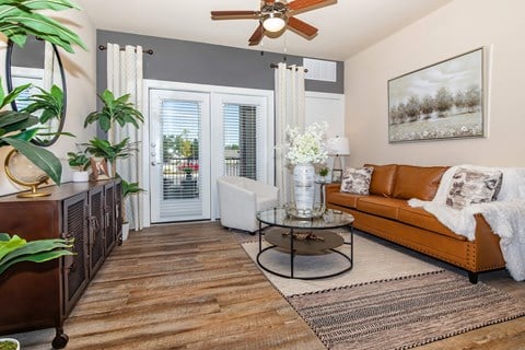 A living room with a brown leather couch and a coffee table.