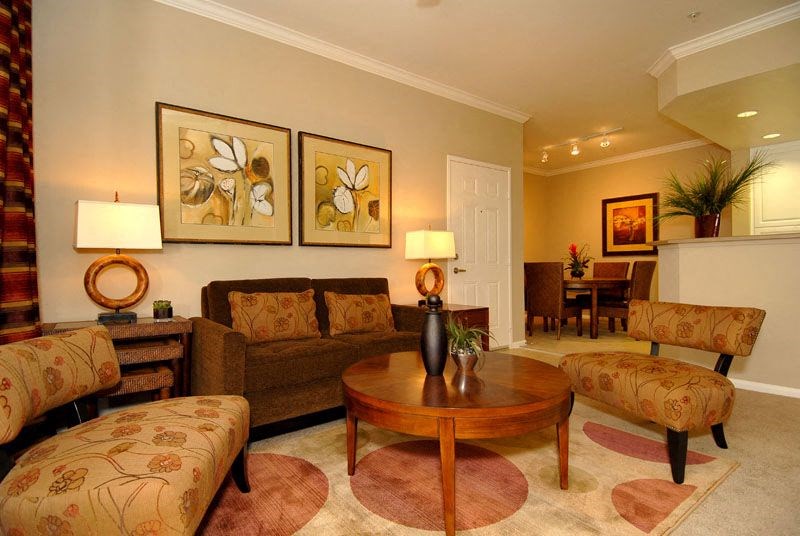 Livingroom with seating, coffee table, and artworkon the wall