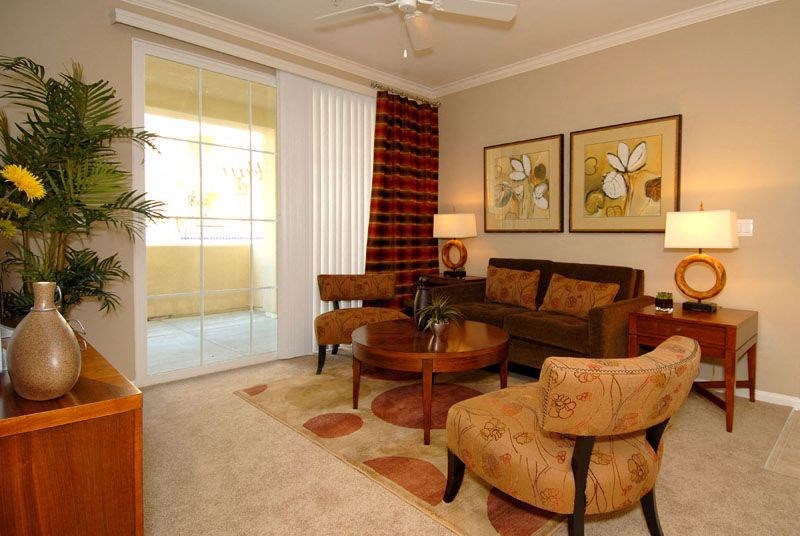 Livingroom with couch, coffeetable, chairs and large windows