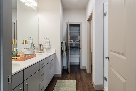 a bathroom with a sink and a mirror and a closet at Parkside at Littleton Village, Littleton, CO