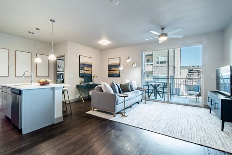 a living room with a couch and a kitchen at Parkside at Littleton Village, Littleton, CO