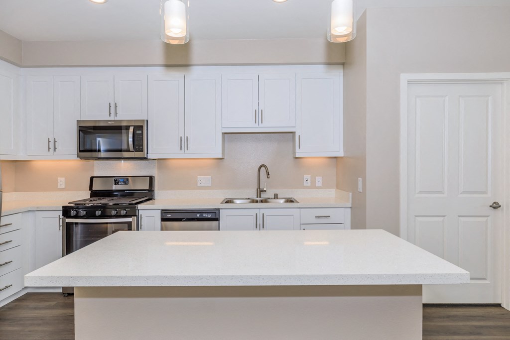 a kitchen with white cabinets and a white counter top