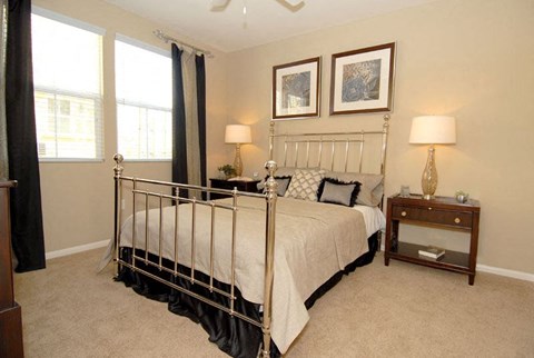 Bedroom with night stand and large windows