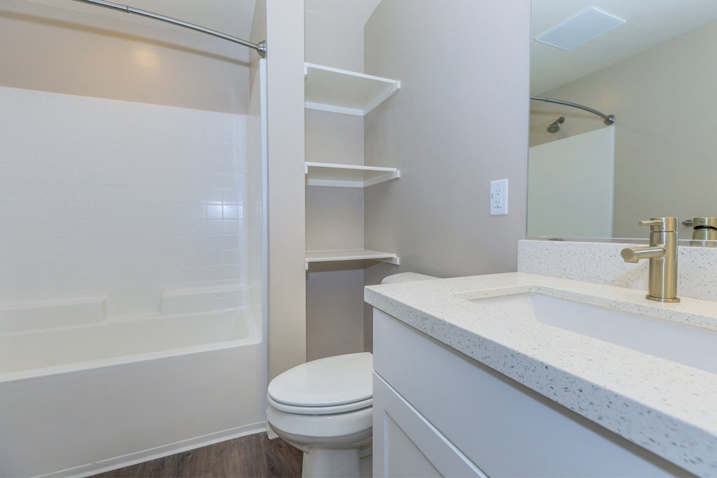 a bathroom with a toilet and a shower and a sink