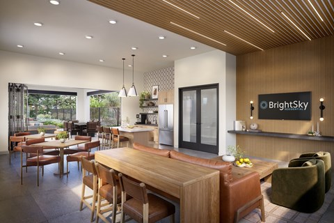 A modern dining room with a wooden table and chairs.