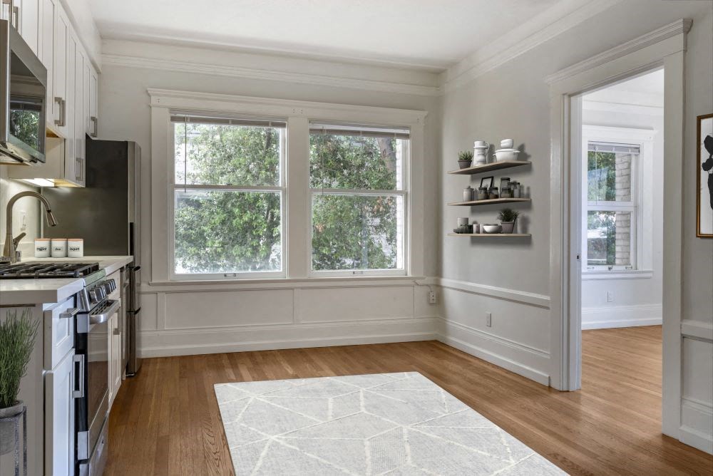 a kitchen with a stove top oven next to a window