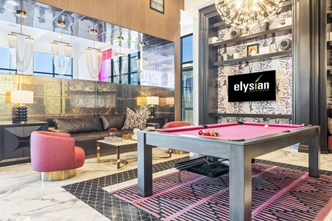 A room with a pool table and a sign that says "Elysian".