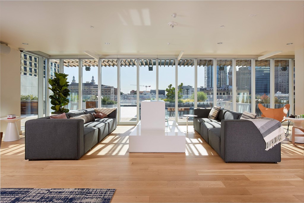Lobby with two grey couches and a white table.