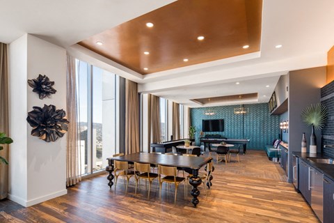 A modern dining room with a wooden table and chairs.