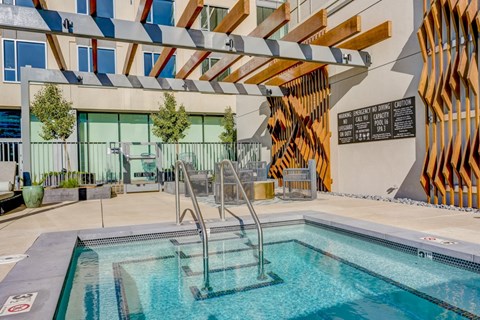 A pool with a slide and a sign that says