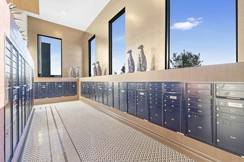 A modern kitchen with a long counter and a tiled floor.