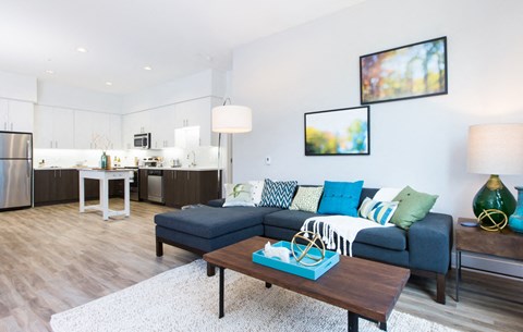 A modern living room with a blue couch and a coffee table.