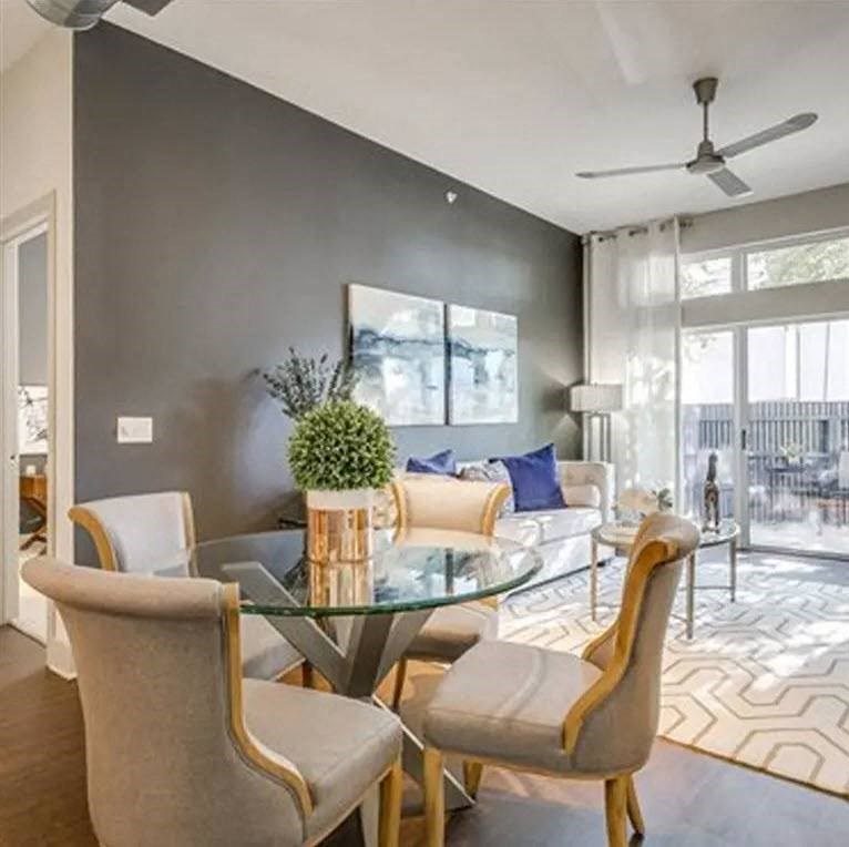 a living room with a table and chairs and a couch at Trend Design District, Dallas, Texas