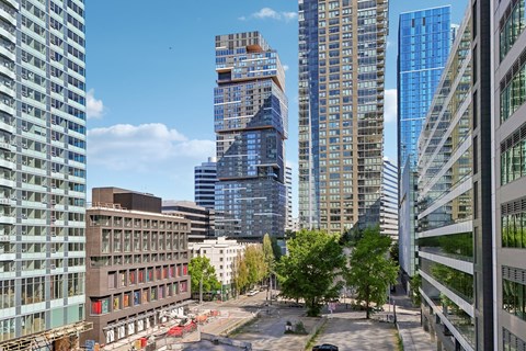 A cityscape with tall buildings and a clear sky.