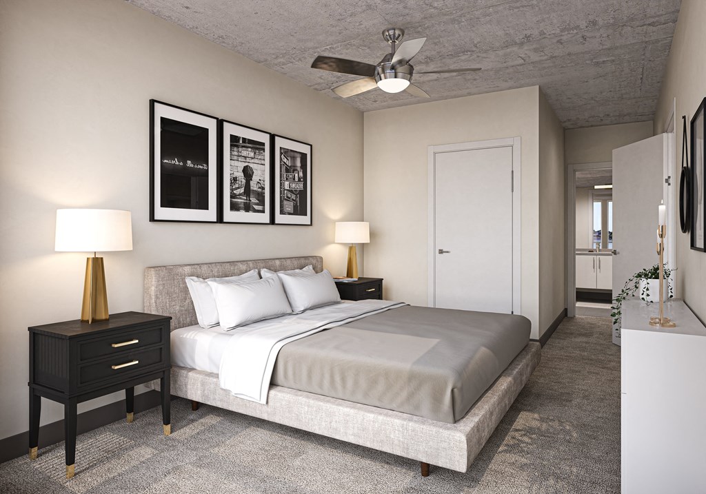 Artizan Apartments in Oakland, CA, with wall-to-wall carpet, large windows, and white walls