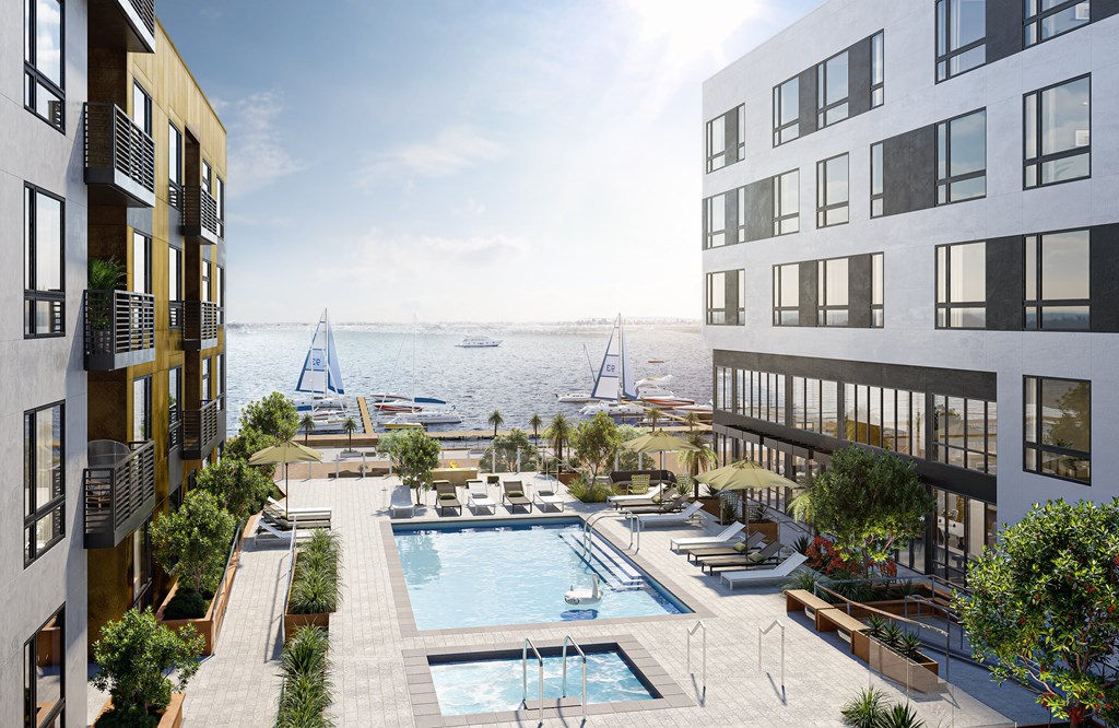 Oakland, CA Apartments - Exterior View of Artizan Apartments Building Surrounded By Lush Landscaping with View of Pool