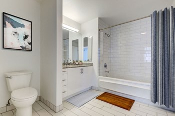 San Francisco Apartments for Rent - 333 Fremont-Bathroom -White and Black Tiles, Silver Appliances, Granite Counter, Bathtub, and White Vanity - Photo Gallery 2