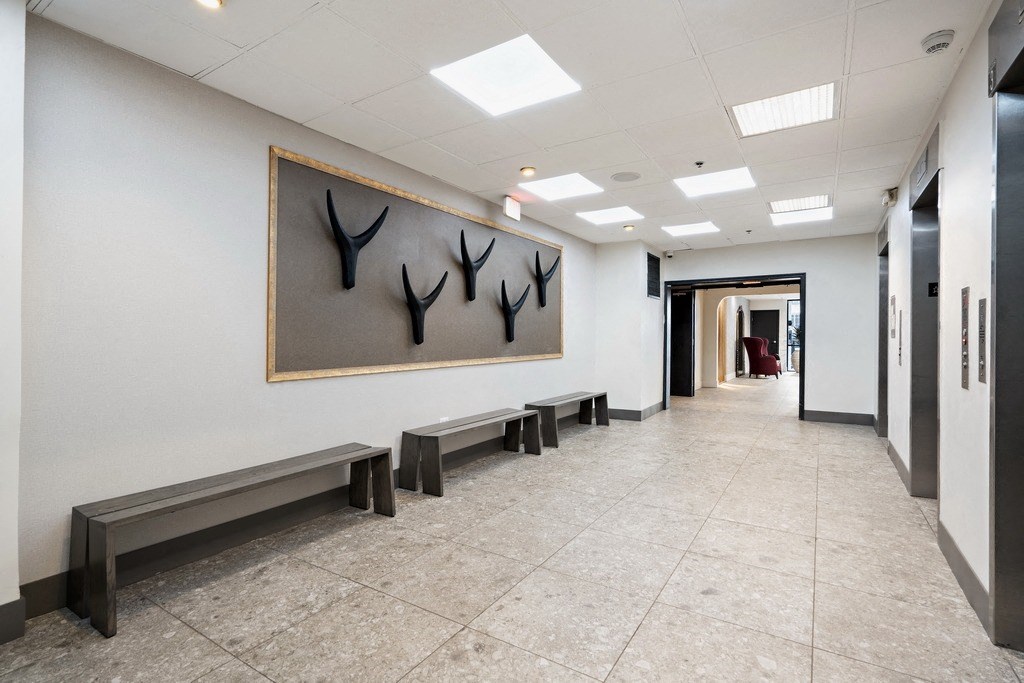 Hallway with bench seating and elevators