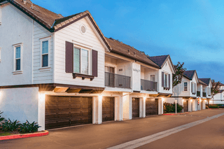 a row of houses with garages at dusk at Barrington Place, California, 91739