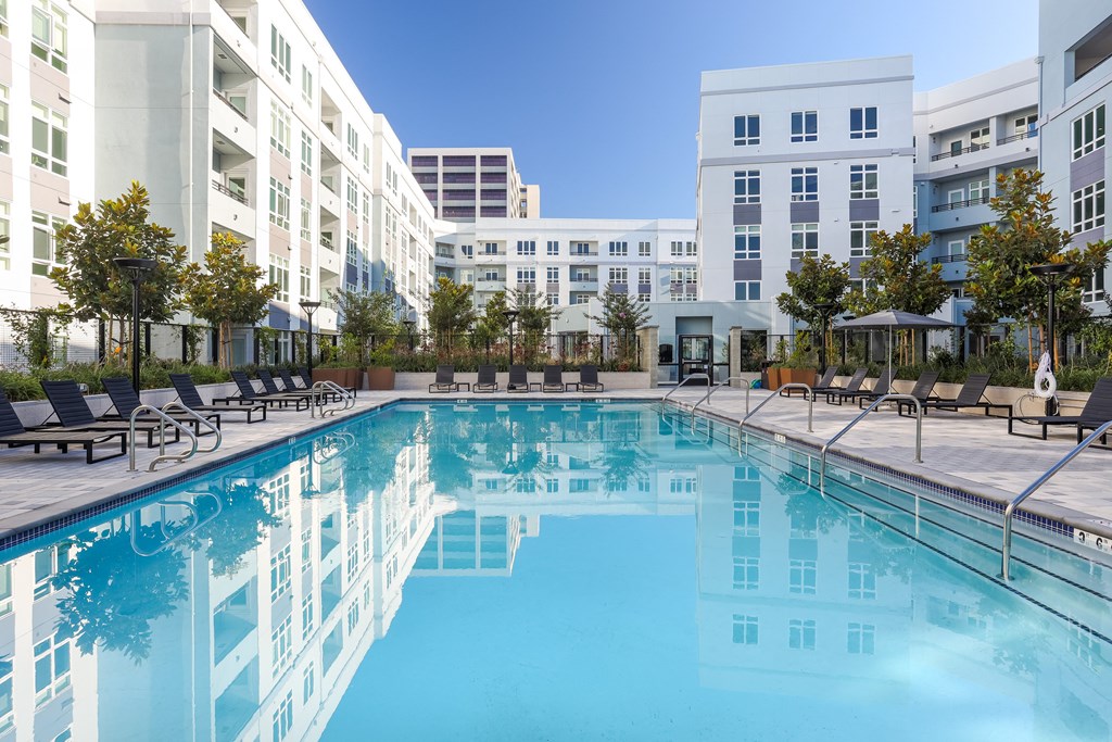 a swimming pool with a building in the background