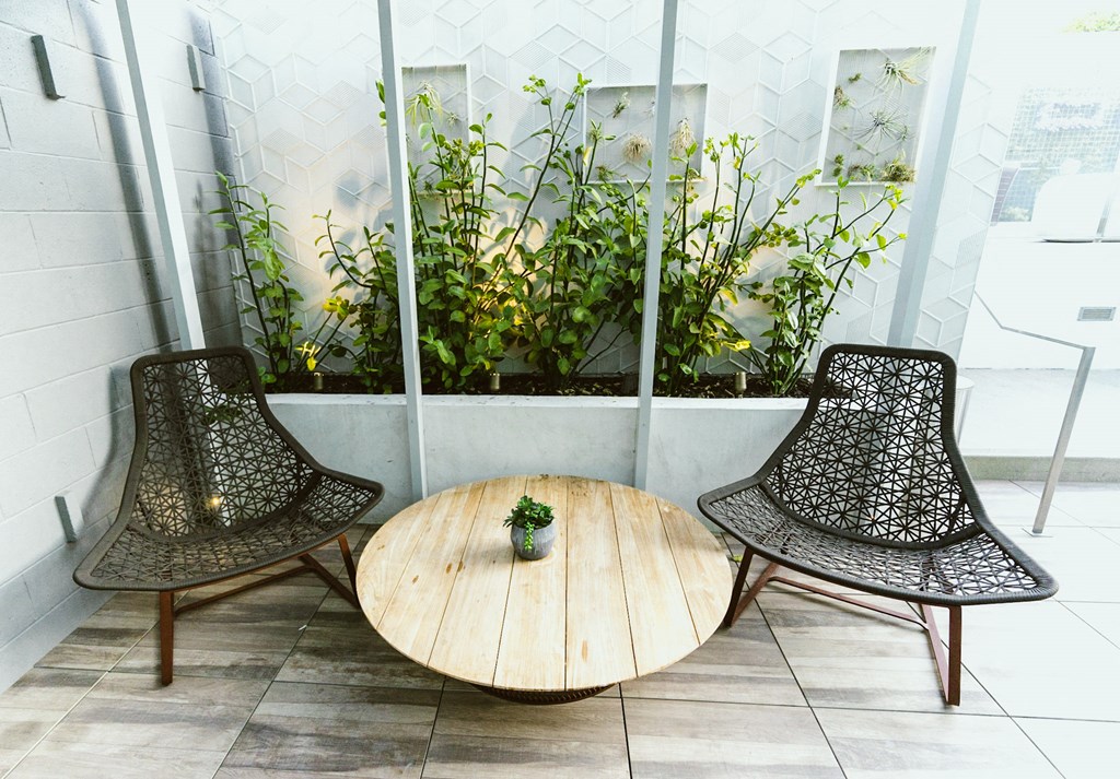 a table and three chairs in front of a window