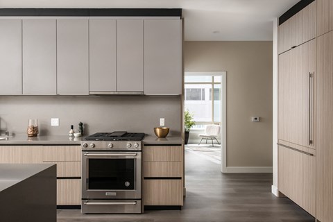 A modern kitchen with a stove and cabinets.