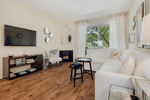 A living room with a fireplace and a television.at Norwalk Metropointe, Norwalk  