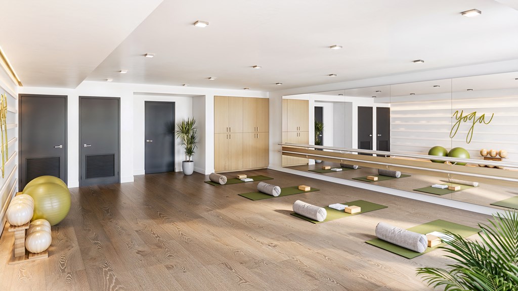 a yoga room with yoga mats on the floor