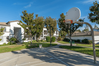 a basketball hoop in a park with houses in the background at Barrington Place, Rancho Cucamonga, CA, 91739