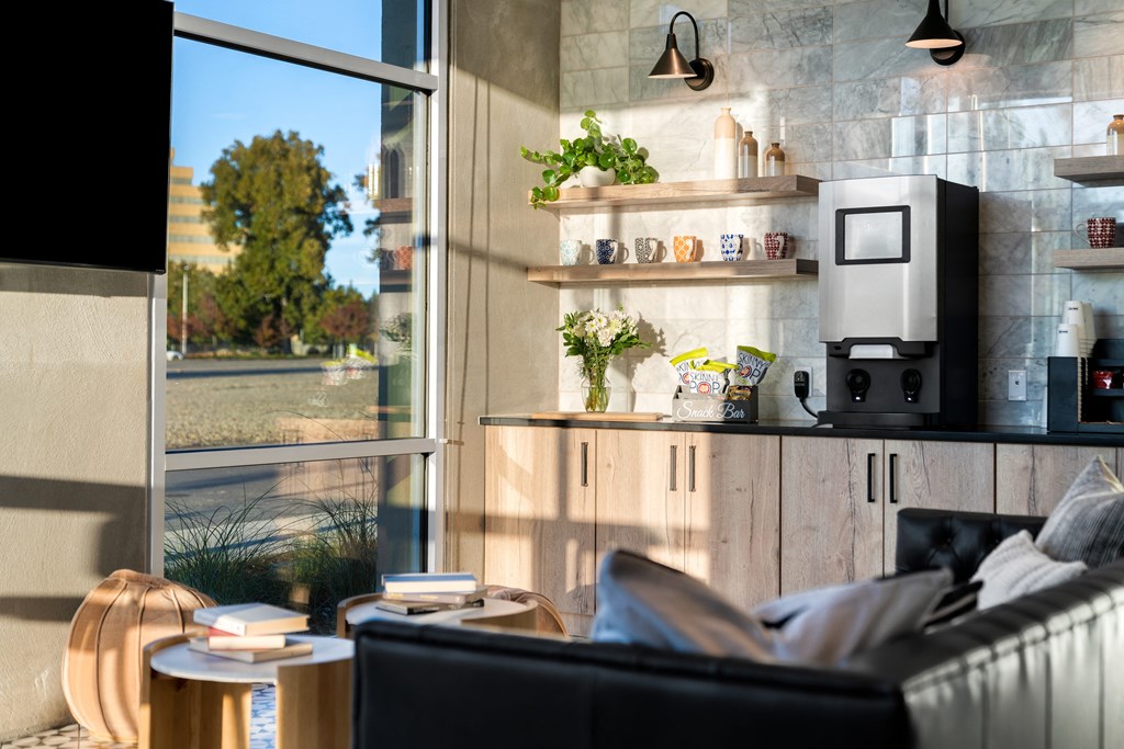 club house with a couch and a coffee maker and a window