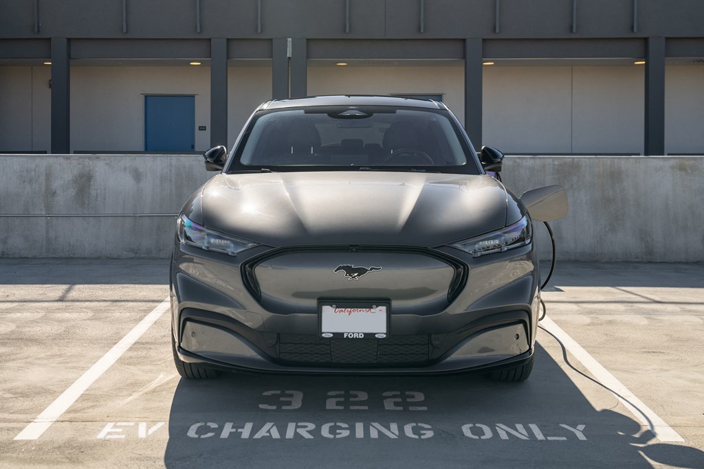 a 2020 tesla model y charging in a parking lot