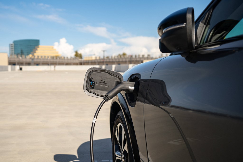 a car is refueling at a gas pump in a parking lot