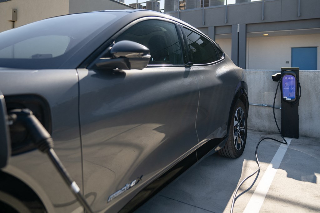 a car is plugged into a electric charger at a charging station