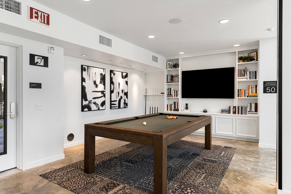 game room with a pool table and a television