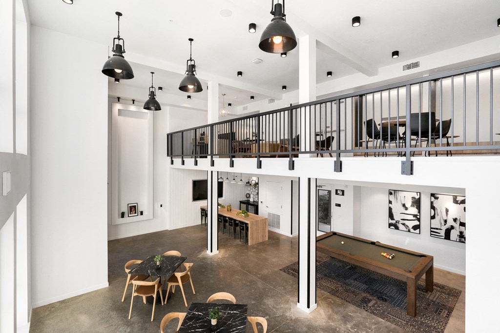 a game room with a pool table and a loft