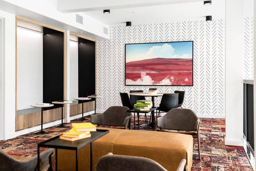 club house with a couch and chairs and a painting on the wall