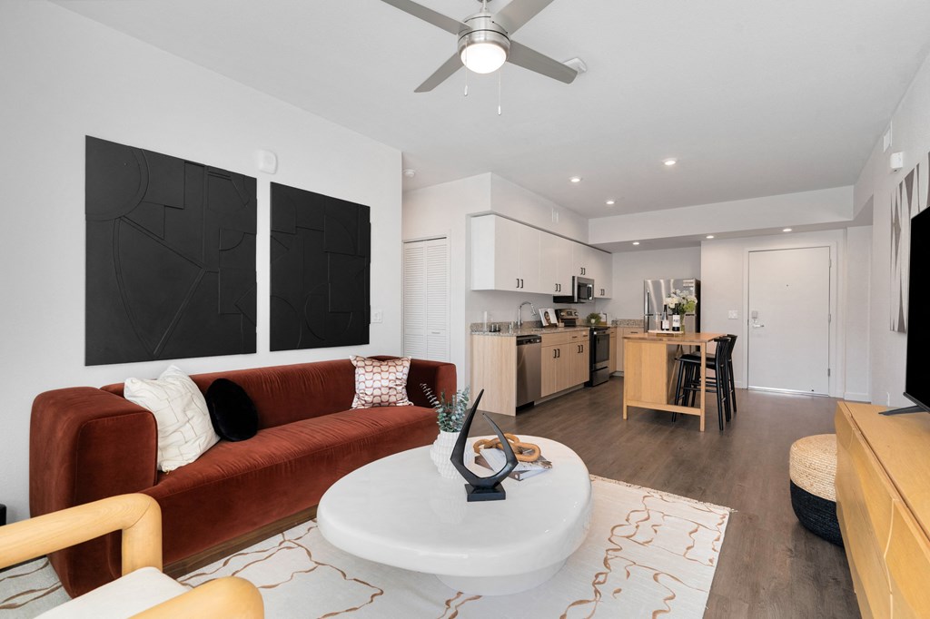 a living room with a red couch and a white table