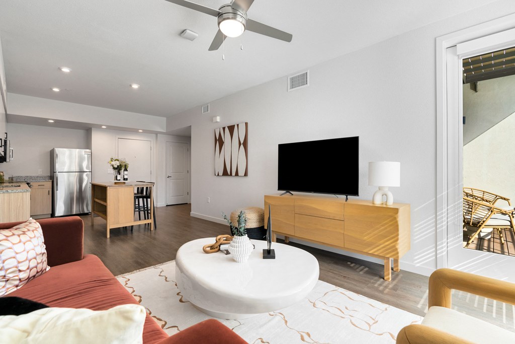 a living room with a couch and a coffee table and a tv