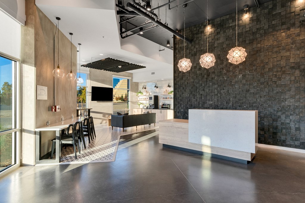 the lobby with a reception desk and a table with chairs