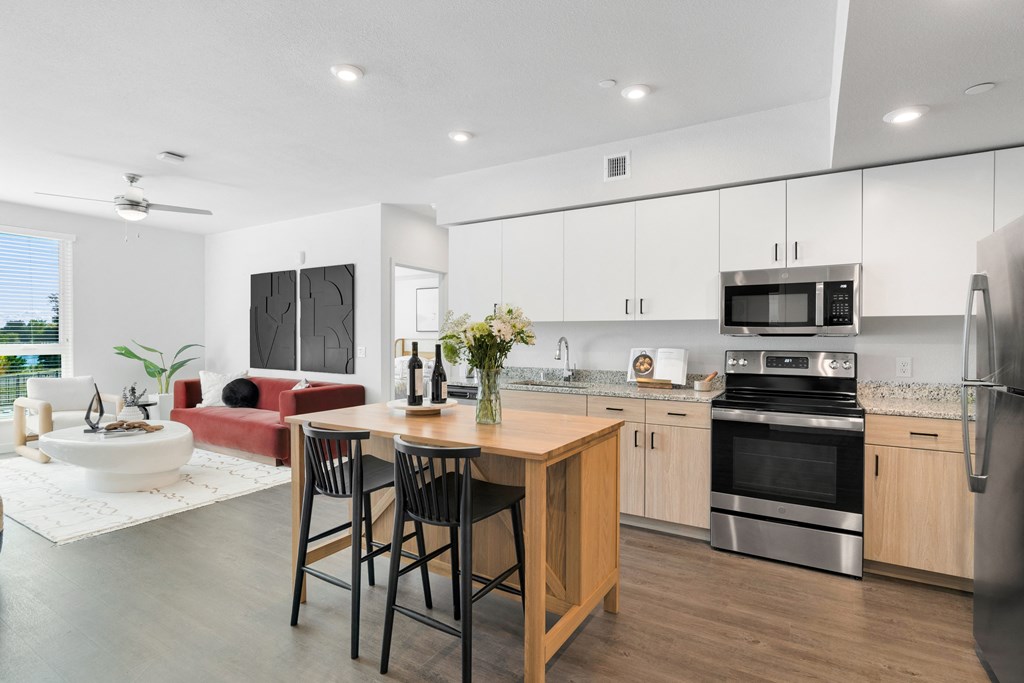an open kitchen and living room with a table and chairs