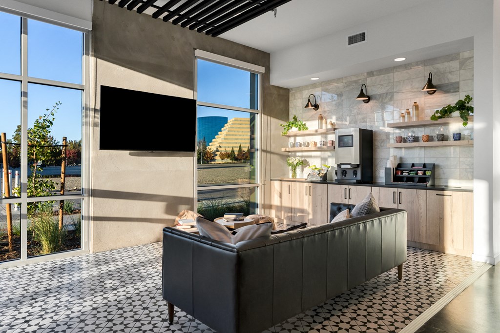 Club house with a black couch and a large window