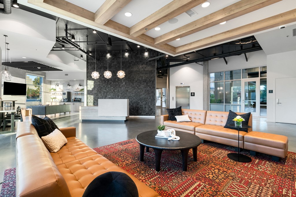 lobby with leather couches and a coffee table