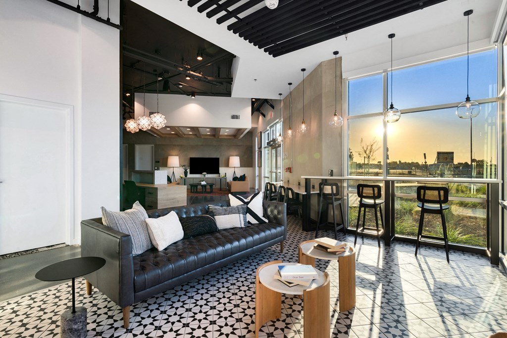 club house with a couch and tables in front of a window