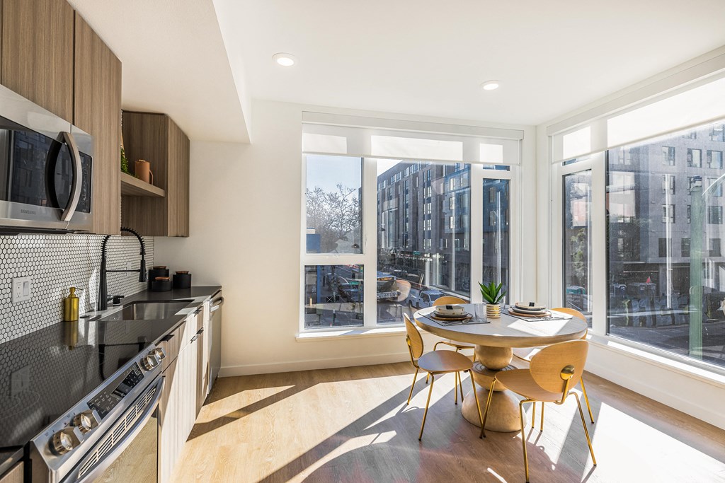 a kitchen with a large window and a table and chairs