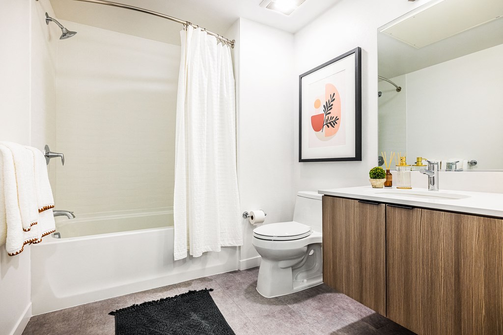 a bathroom with a toilet and a shower and a sink